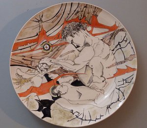 Platter with rock, rust and male figure